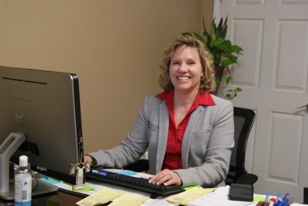 Tana Marshall sits at her desk at Fortress Office In Camden South Carolina